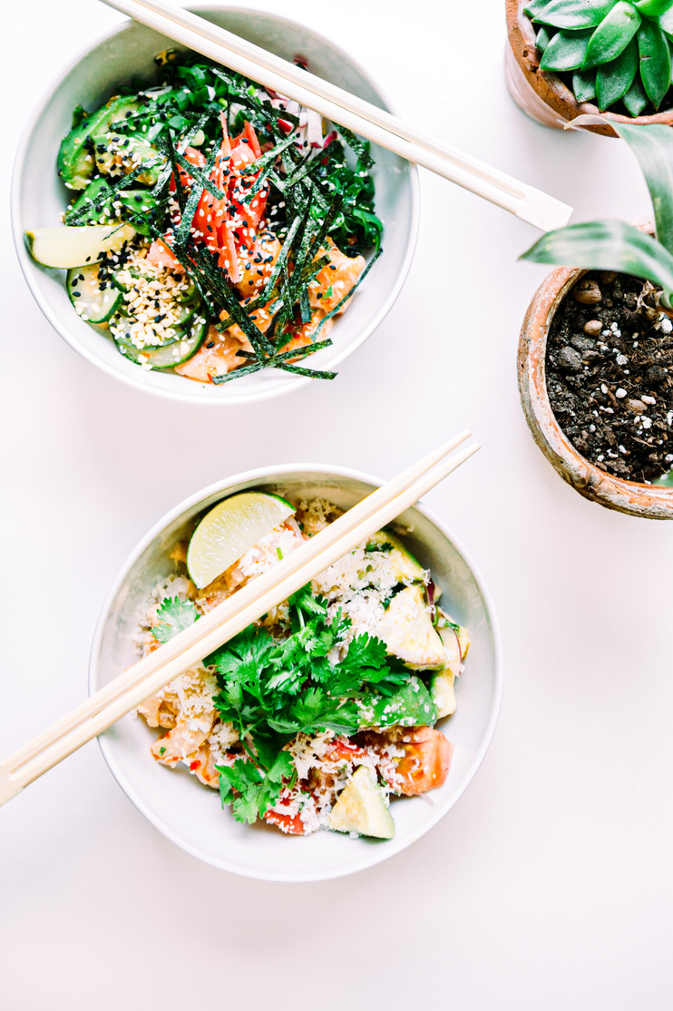 Asian vegetable salads and chopsticks on table